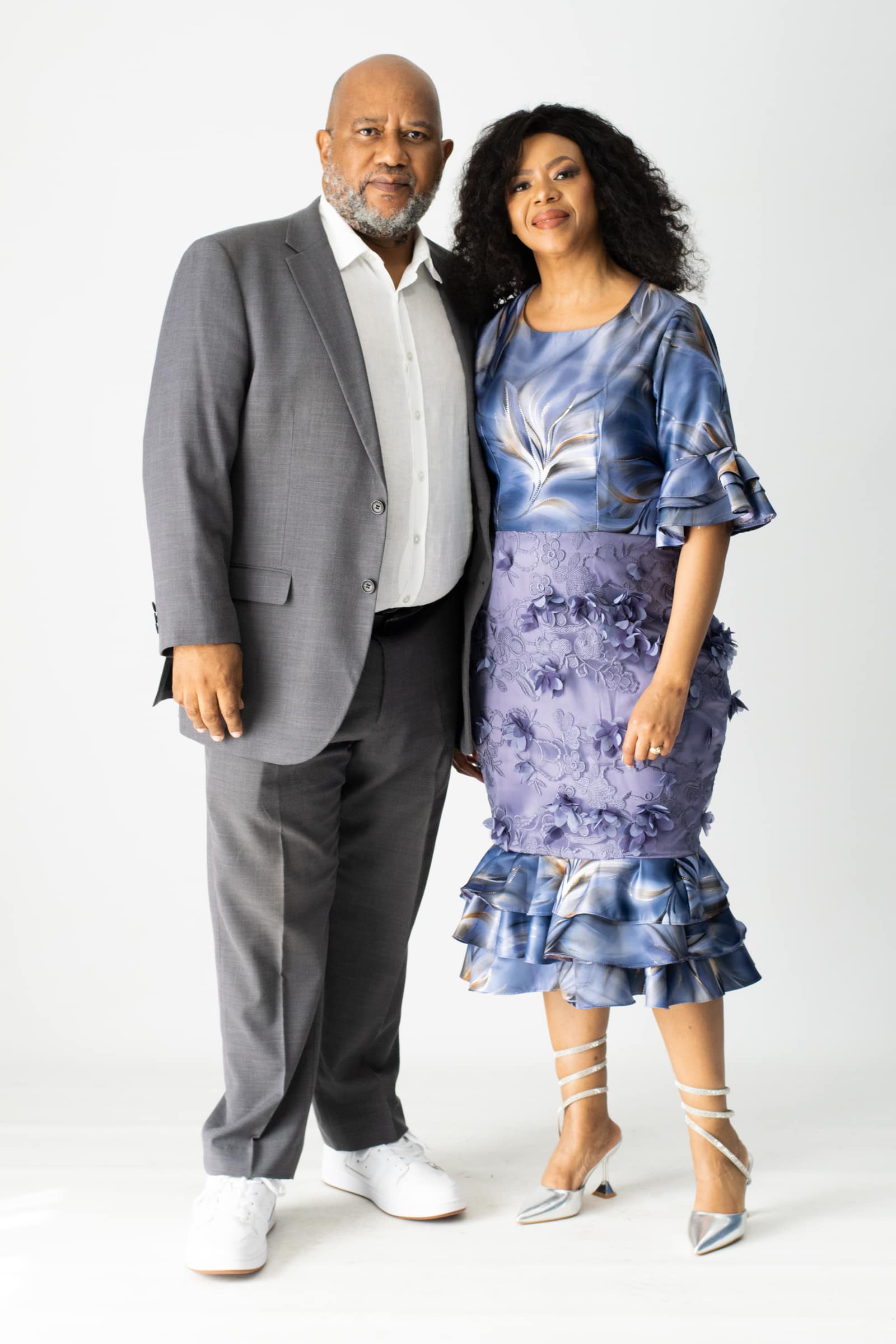 Studio portrait of a formally dressed couple against a white backdrop